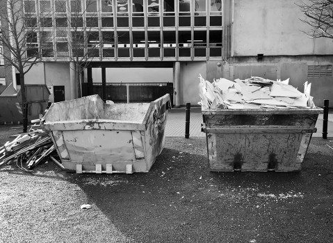 Crew members inspecting commercial waste containers during a site survey