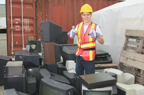 Professionals organizing garage items during clearance in Harrow