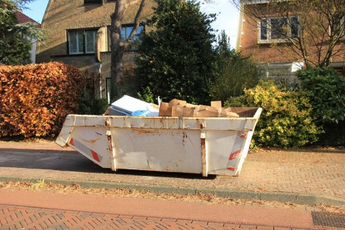 Workers clearing builders' waste in Harrow